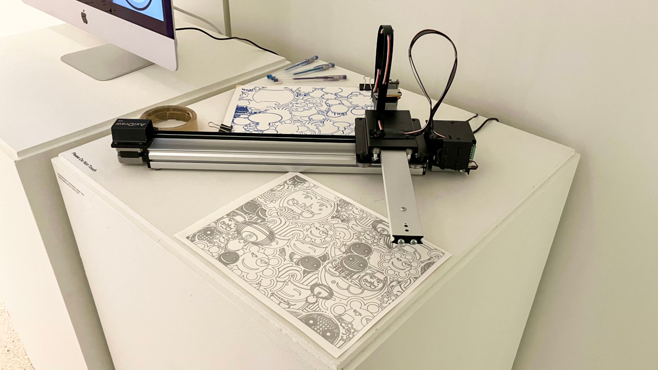 Demonstration of the Axidraw machine automatically illustrating
         generative artwork based on code input onto paper using a gel pen.